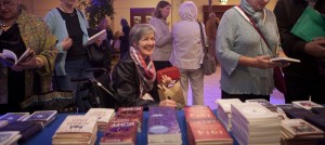 Audience member buying books at Festival event