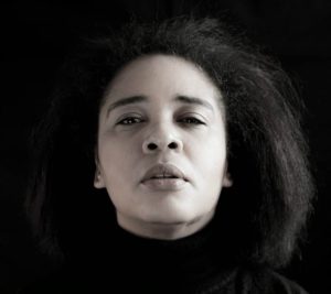 A headshot of a woman staring directly into the camera.